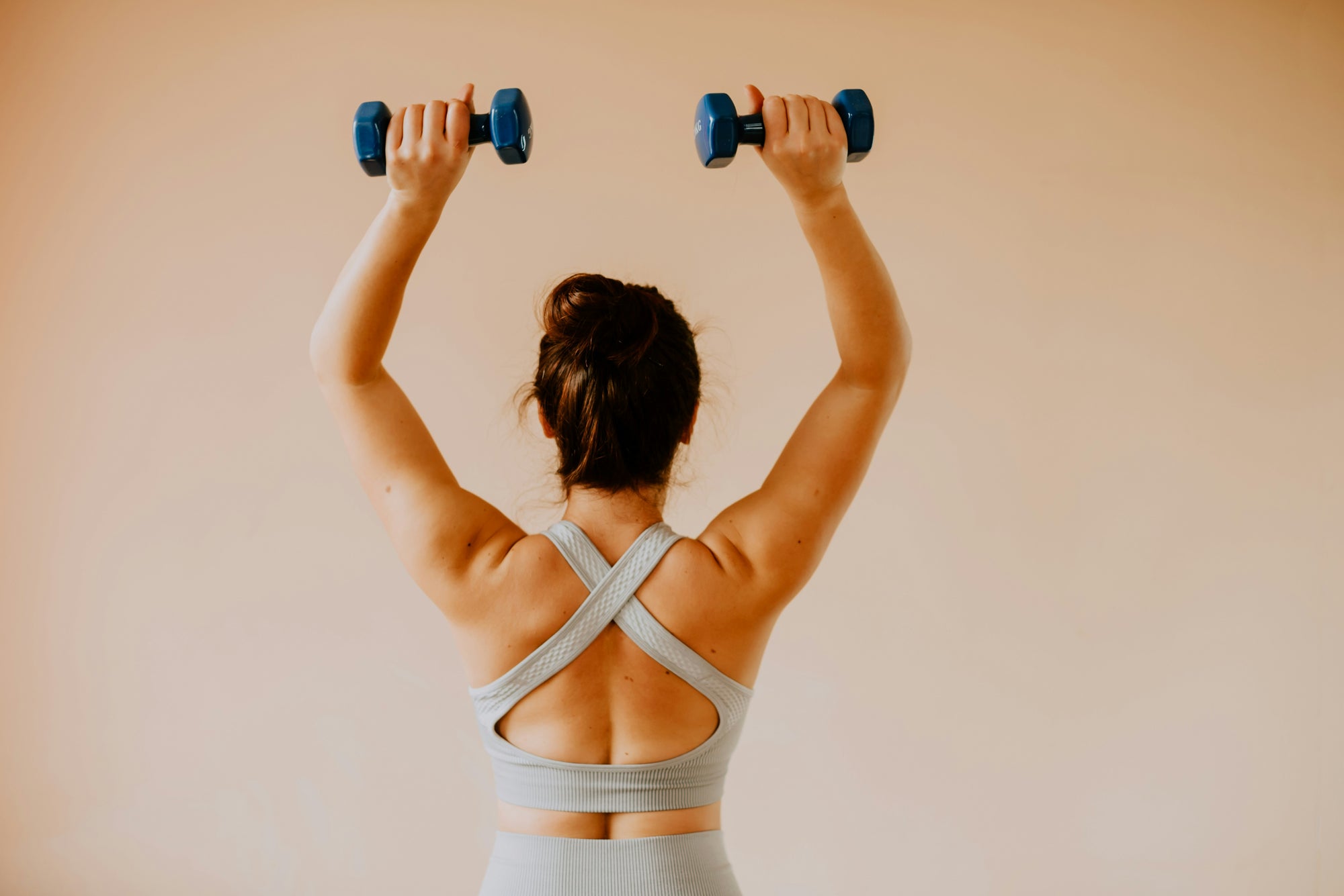 woman in her back holding weights